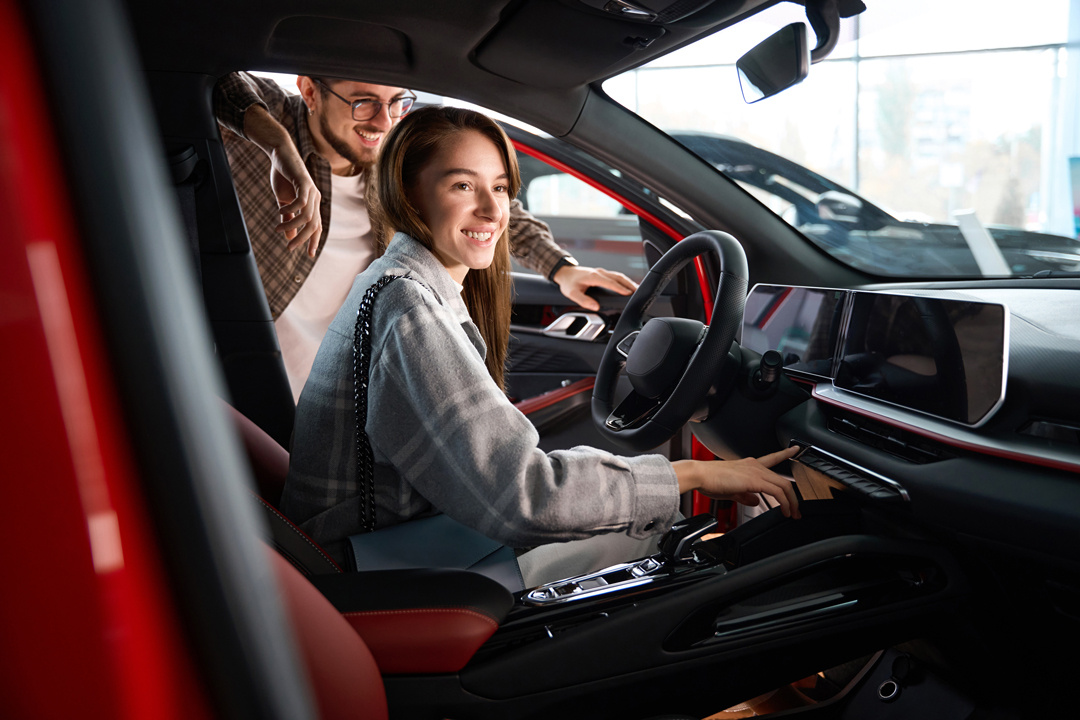 woman-and-man-choosing-model-of-car-in-dealership-2024-01-15-18-48-58-utc-1